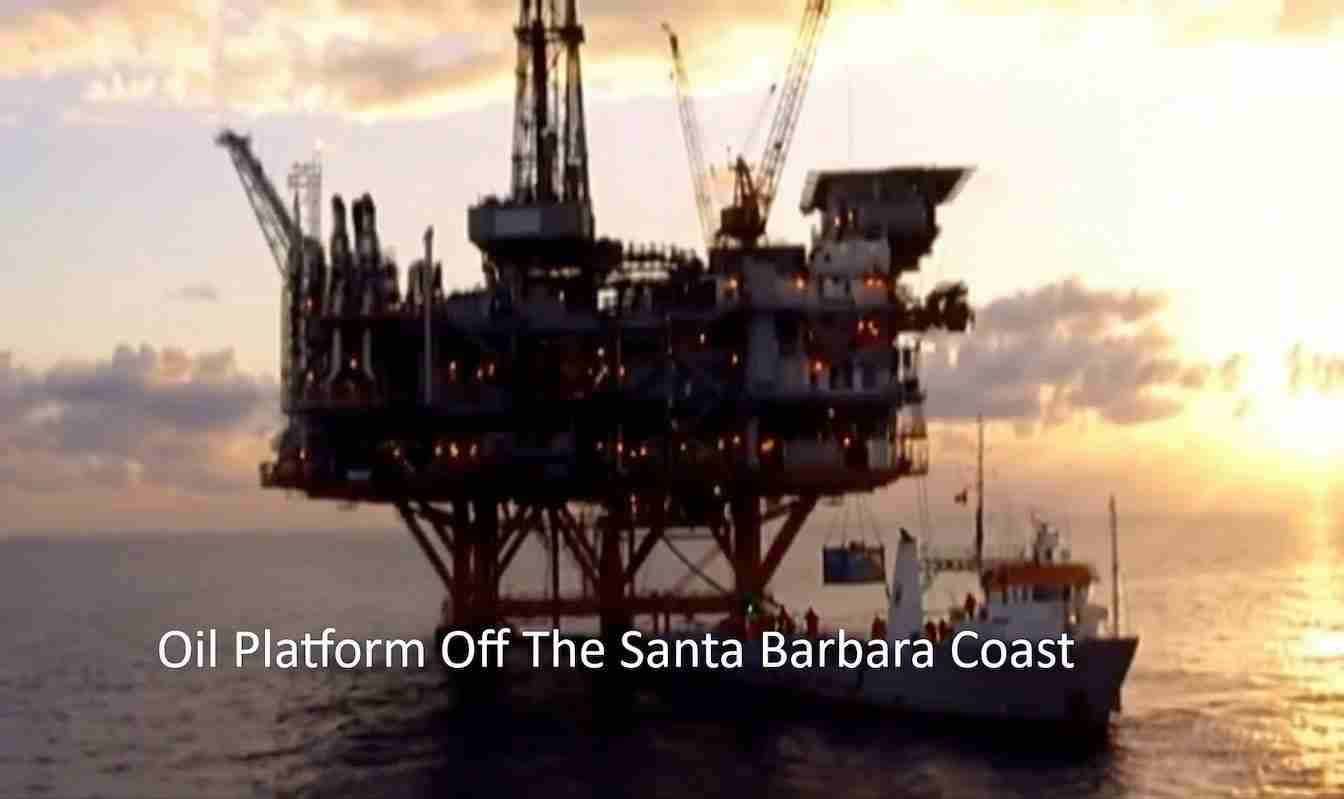 Offshore oil platform on stilts near the Santa Barbara Coast at sunset, with a support vessel nearby
