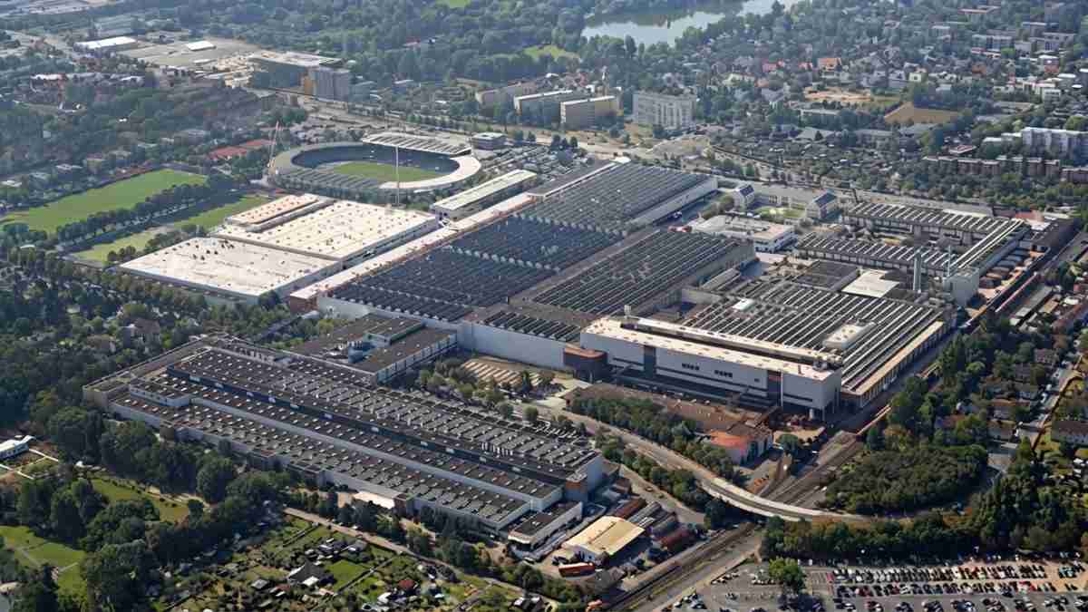 Aerial view of a large stadium and adjacent sports facilities surrounded by parking lots and a city neighborhood.