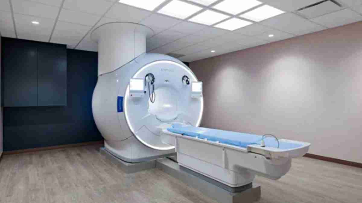 MRI scanner in a clinical room with a patient table ready for imaging in place bed extended.