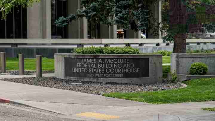 Stone sign for the James A. McClure Federal Building and United States Courthouse at 550 West Fort Street, with greenery around it.