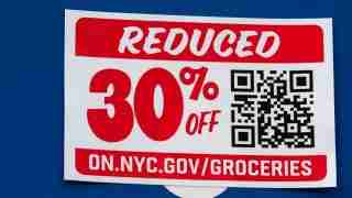 Promo sign: 'REDUCED 30% OFF' with a QR code and the URL on.nyc.gov/groceries on a blue background.