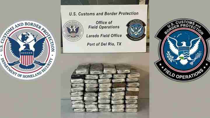 Stack of tightly wrapped packages on a table, with U.S. Customs and Border Protection logos on both sides and a sign for the Laredo Field Office in the center.