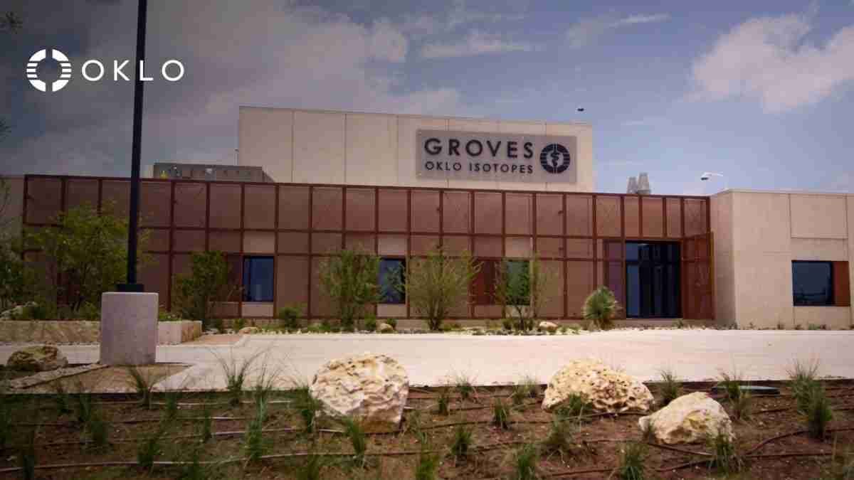 Exterior view of the Groves OKLO Isotopes building with the OKLO logo in the foreground, desert landscaping in front.